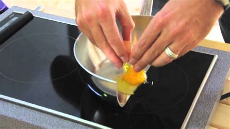 To Demonstrate How Induction Cooking Works A Chef Cooks Eggs Bacon