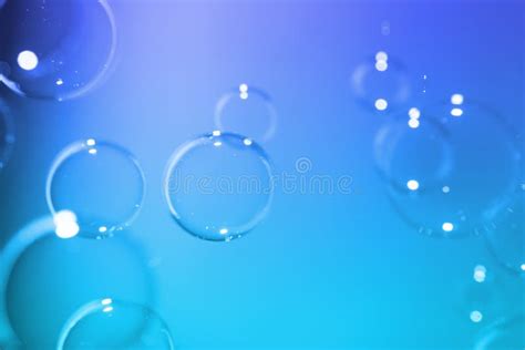 Abstract Clear Transparent Bubbles Float On Dark Blue Texture