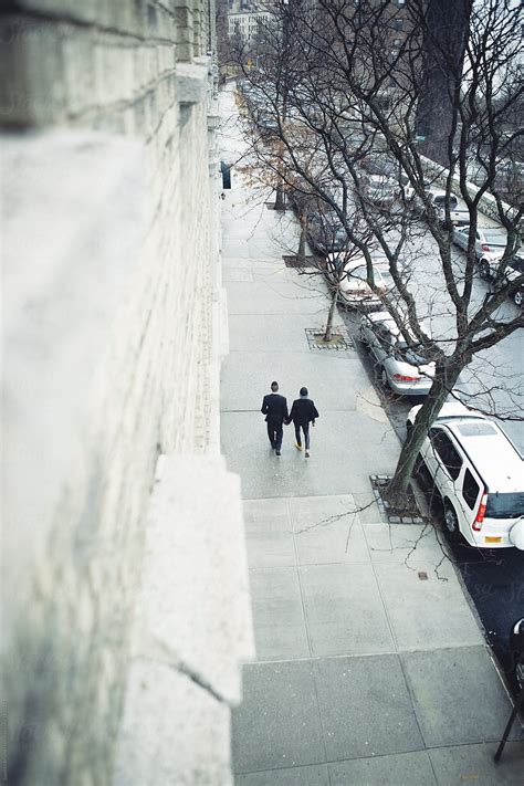 Gay Men Lovers Walking Together Hand In Hand In A New York Street Sidewalk By Stocksy