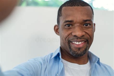 Portrait Of African American Handsome Man Smiling Friendly Aking Selfie