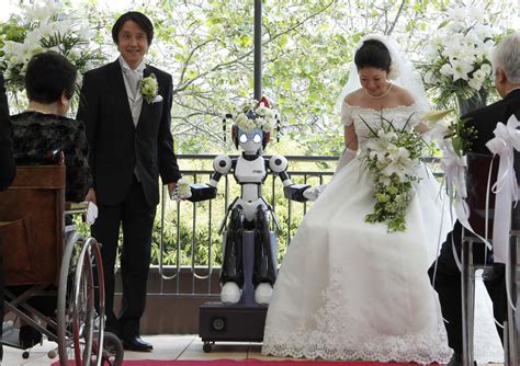 Eyes flashing, robot conducts wedding in Tokyo