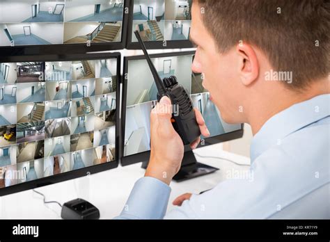 Male Security Guard Talking On Walkie Talkie Stock Photo Alamy