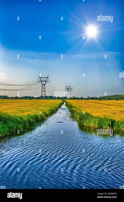 Dutch Landscape With A Canal And Grass Fields With Mirror Reflection In