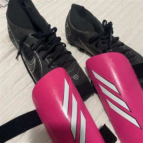 Black Nike soccer cleats and pink shin guards Used... - Depop