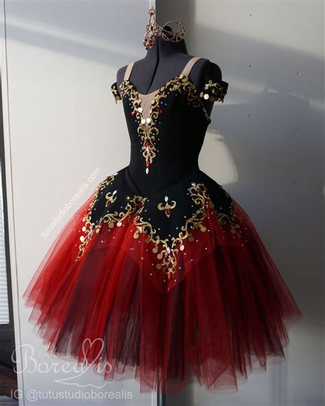 A Black And Red Dress With Gold Accents