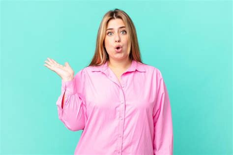 Premium Photo Curvy Pretty Blonde Woman Looking Surprised And Shocked With Jaw Dropped