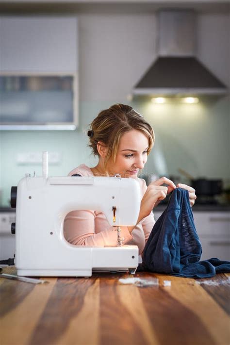 Beautiful Young Woman Sewing Clothes With Sewing Machine Stock Image