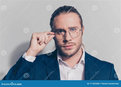 Close Up Portrait Of Attractive Man Holding With One Hand Glasses On