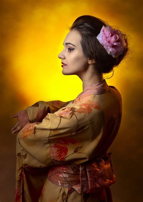 Traditional Asian Japanese Beautiful Geisha Woman Wears Kimono Bride With A Red Umbrella In A