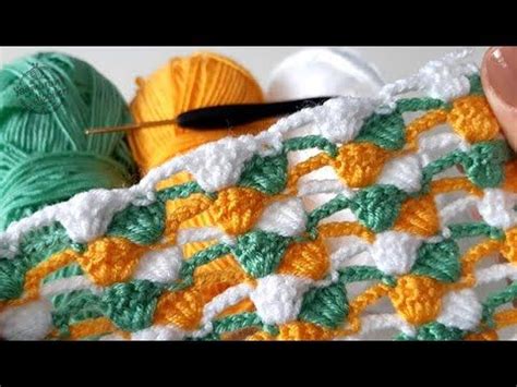 Someone Crocheting With Yarn On Top Of A Blanket