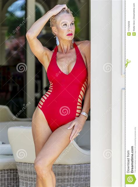 Gorgeous Blonde Model Posing Outdoors Near A Swimming Pool Stock Photo