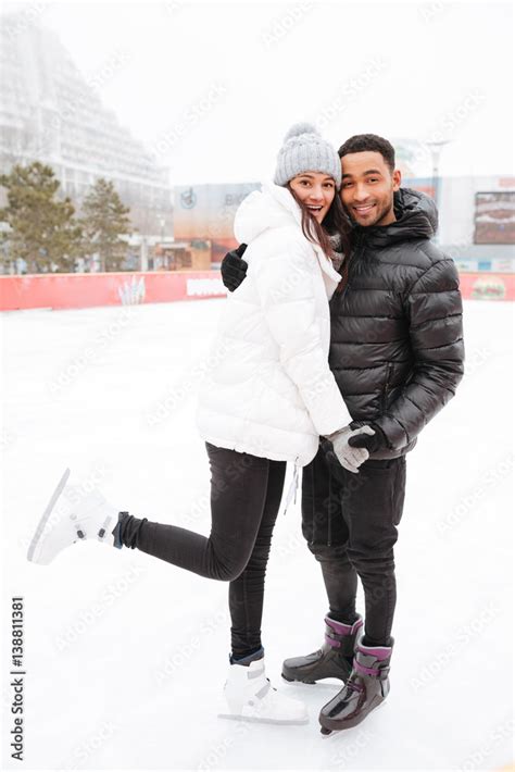 Loving couple skating at ice rink outdoors. Stock Photo | Adobe Stock