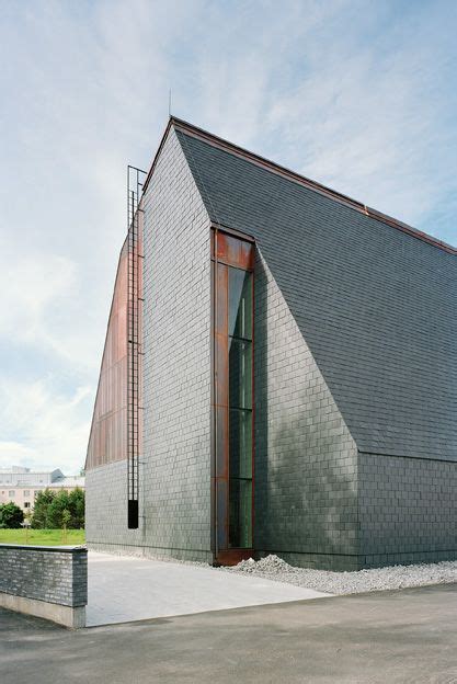 The Building Is Made Out Of Bricks And Has A Triangular Roof That