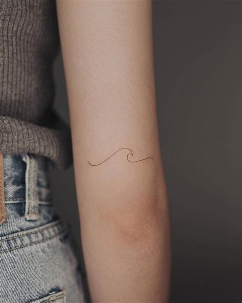 Minimalist Wave Tattoo On The Tricep