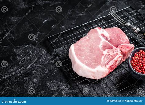 Uncooked Raw Pork T Bone Chop Meat Steak On Grill Black Background