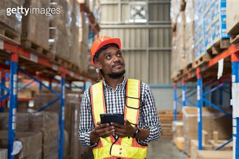 Male Warehouse Worker Holding Tablet During Working In Storage