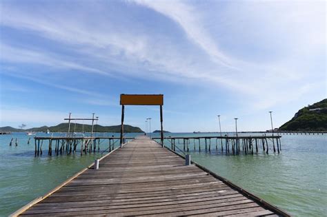 Premium Photo Empty Wooden Sign On A Wooden Bridge Leading Into The