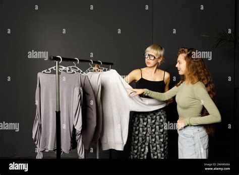 Stylist Designer Helping Choose Clothes Dress To Customer Client Stock