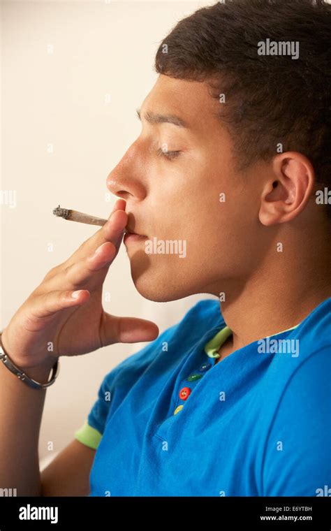 Teenage boy smoking Stock Photo - Alamy