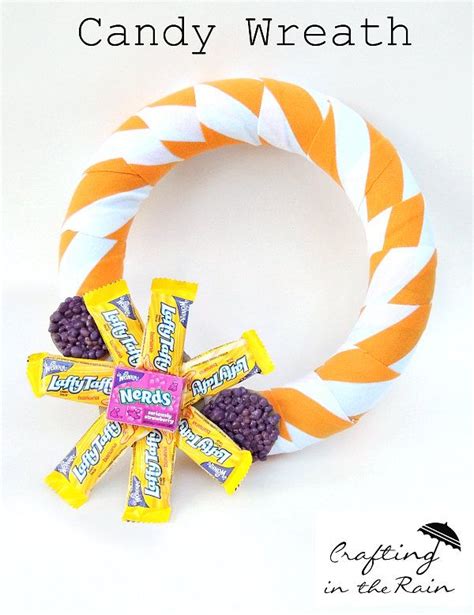 an orange and white wreath made out of candy bars with the words ...