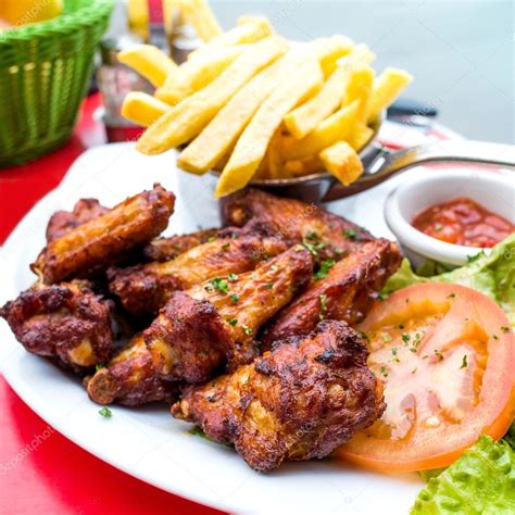 Chicken Wings With Sauce And Golden French Fries Stock Photo Ilolab