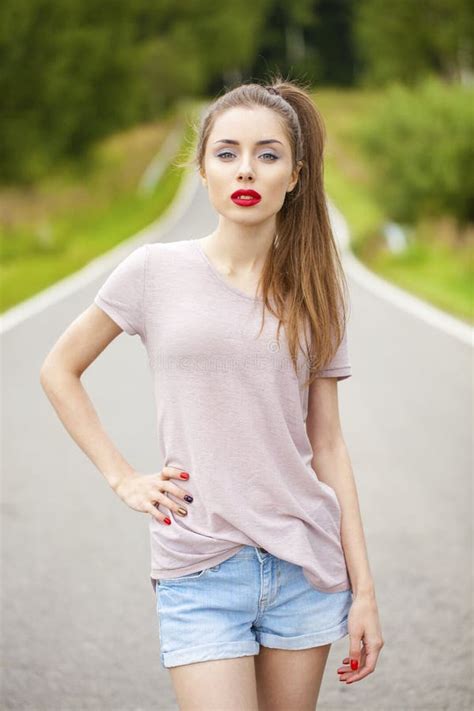 Beautiful Brunette Woman Posing Against Summer Park Bright Sunny