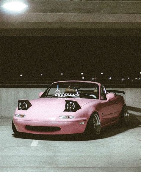 A Pink Sports Car Parked In A Parking Garage