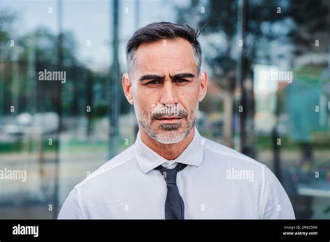 Individual Close Up Portrait Of Serious Mature Businessman Looking