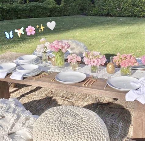 A Table With Flowers And Plates On It