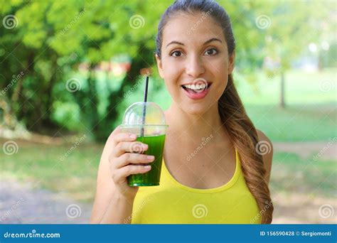 Young Beautiful Sporty Woman Drinking Green Detox Smoothie Fitness