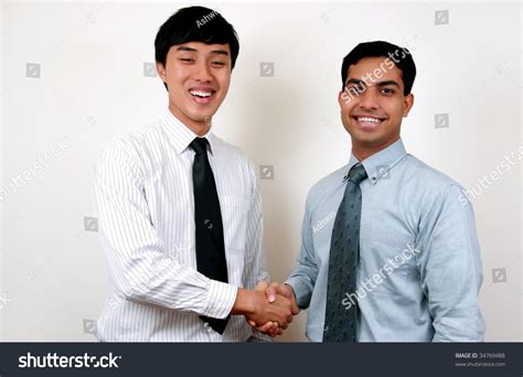 Indian And Chinese Businessman Shaking Hands Stock Photo 34769488