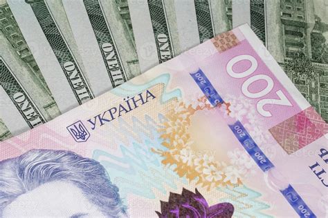 Two Hundred Ukrainian Hryvnia Banknote Against Dollars Banknotes