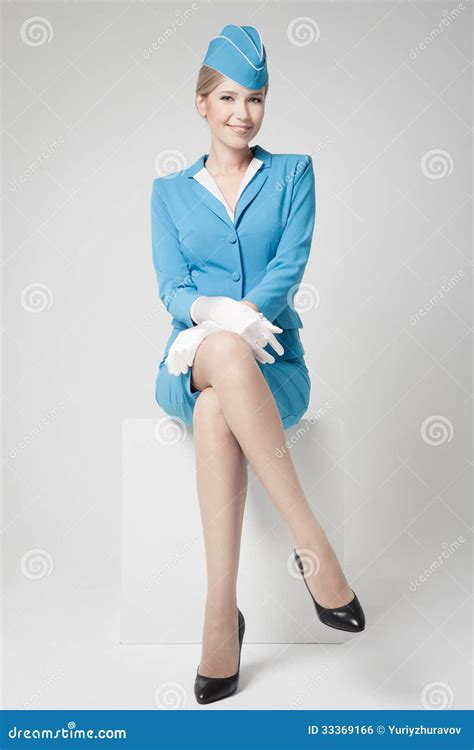 Charming Stewardess In Blue Uniform On Gray Background Royalty Free