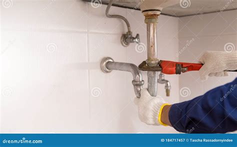 Plumber Fixing White Sink Pipe With Adjustable Wrench Stock Image