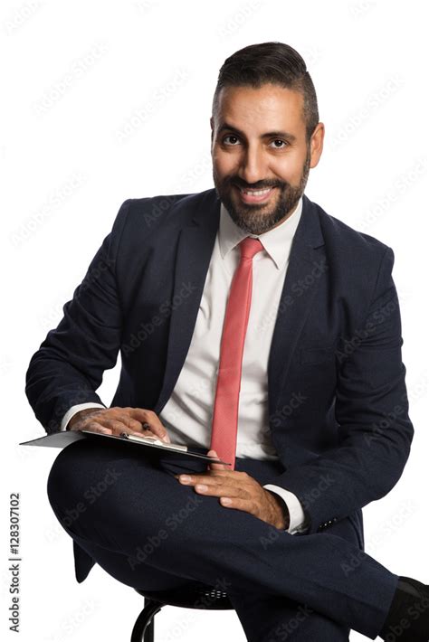 Handsome Businessman In A Blue Suit And Red Tie Sitting Down In Front