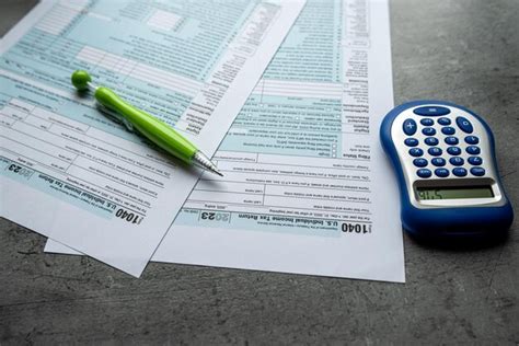 Premium Photo Individual Tax Return Forms With Pen Calculator