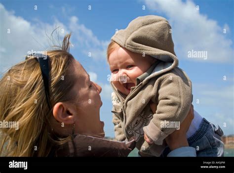 Horizontal Close Up Of A Young Mother Playing Peek A Boo With Her