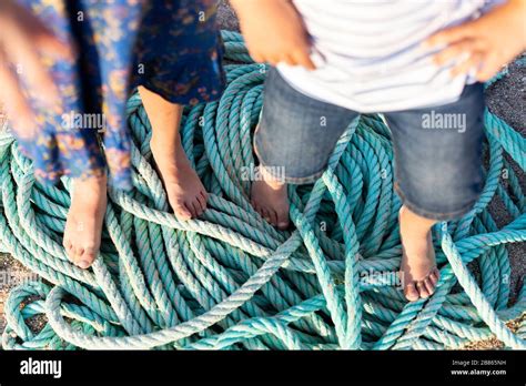 The Feet Of Two Children On Fishing Ropes Stock Photo Alamy