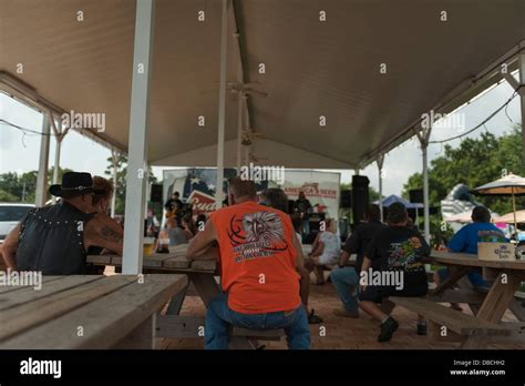 People Enjoying Some Food While Attending The Gator Harley Davidson