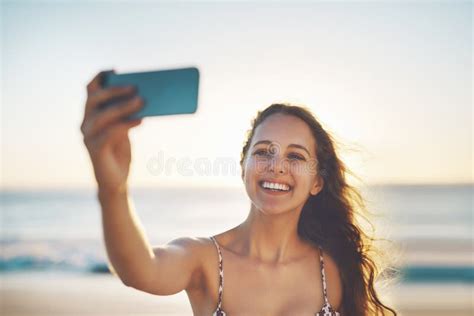 Ill Get So Many Likes A Young Woman Taking A Selfie On The Beach