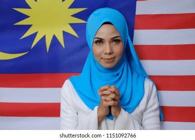 Muslim Woman Happy Holding Malaysian Flag Stock Photo