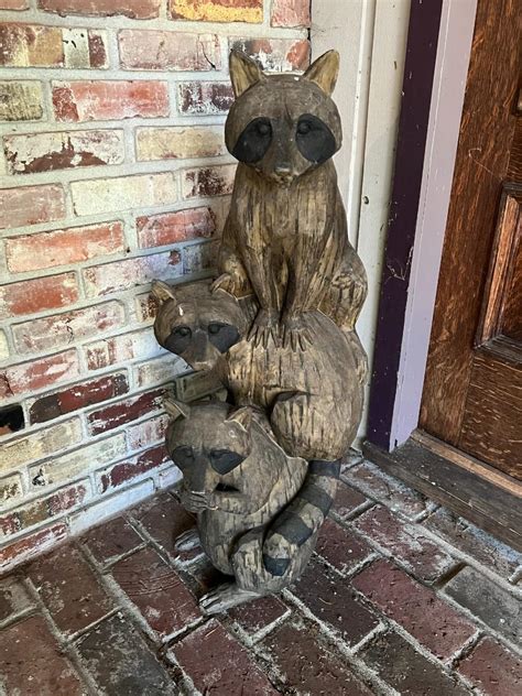 Adorable Outdoor Statue Of Three Raccoons