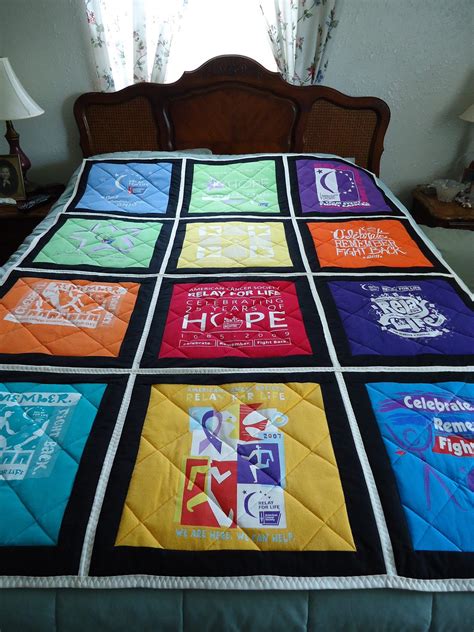 A Bed With A Quilt Made To Look Like It Has Many Different Colors On It