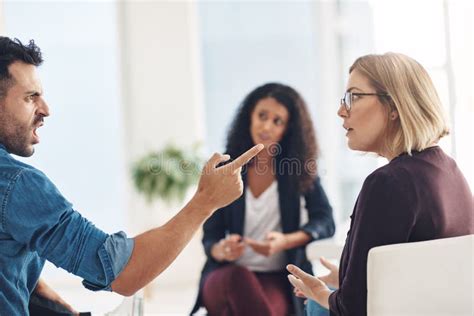 Angry Couple Talking Arguing And Fighting During Marriage Counseling