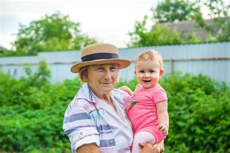 Premium Photo Grandmother With Her Great Granddaughter In Her Arms