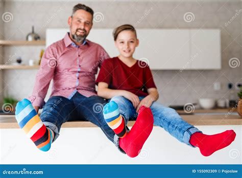 Mature Father With Small Son Sitting On Kitchen Counter Indoors Having Fun Stock Image Image