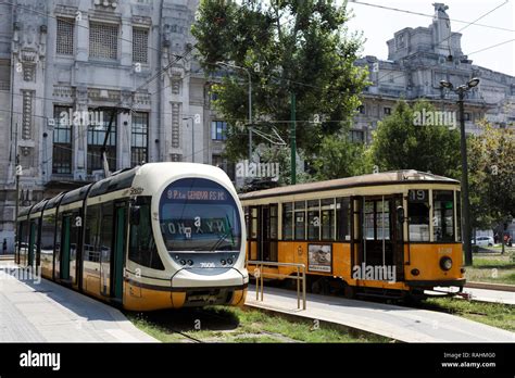 Milan, Italy - August 5, 2018: Modern and retro styled trams on piazza IV Novembre at Central ...