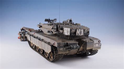 A Toy Army Tank Is Shown On A White Background