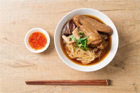 Premium Photo Braised Duck Noodles With Brown Soup