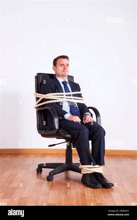 Businessman Tied Up With A Rope Struggle To Get Free Stock Photo Alamy